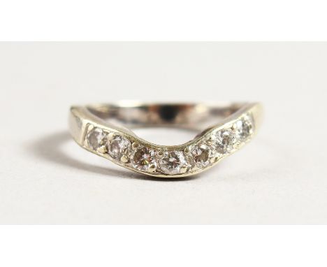 AN 18CT GOLD DIAMOND AND WISHBONE RING.