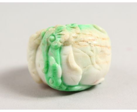 A CHINESE CARVED WHITE JADE RING.