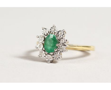 A 9CT GOLD OVAL, EMERALD AND DIAMOND CLUSTER RING.