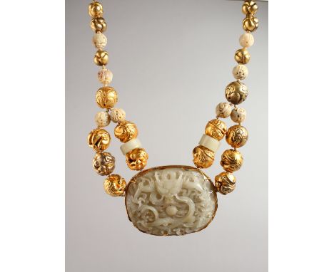 A SUPERB SILVER GILT AND CHINESE CARVED JADE NECKLACE set with a large jade pendant carved with a dragon. 3ins x 4ins with si