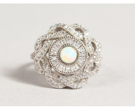 A SILVER AND GILSON OPAL RING.