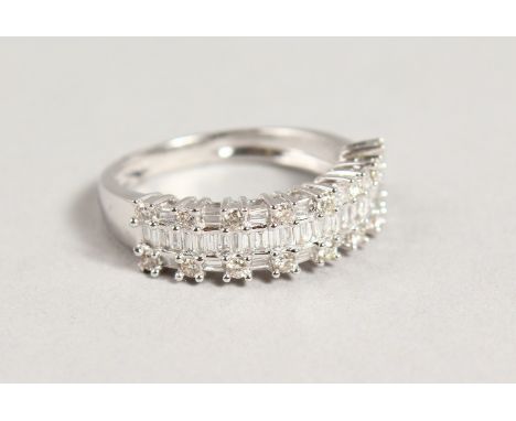 AN 18CT GOLD THREE ROW DIAMOND HALF HOOP RING.