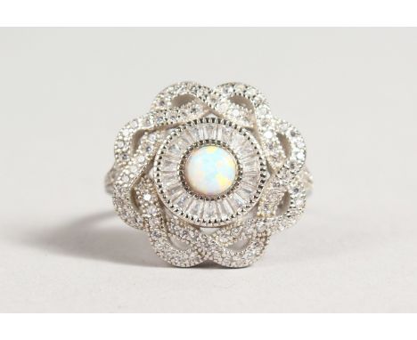 AN ART DECO STYLE SILVER GILSON OPAL CIRCULAR DRESS RING.