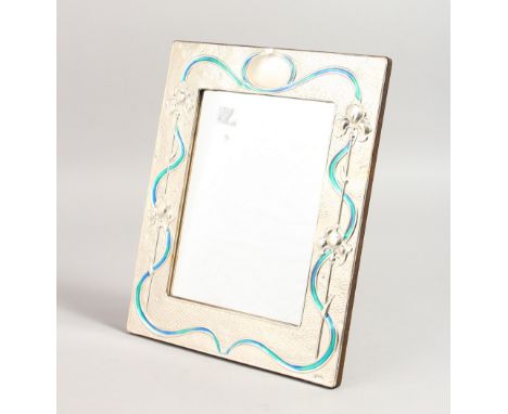 A LARGE SILVER AND ENAMEL PHOTOGRAPH FRAME. 11ins x 9ins.