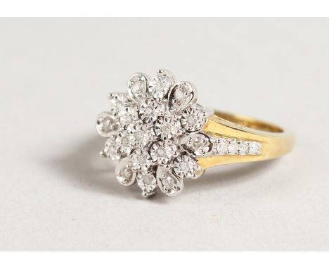 A 9CT GOLD DIAMOND FLOWERHEAD CLUSTER RING.