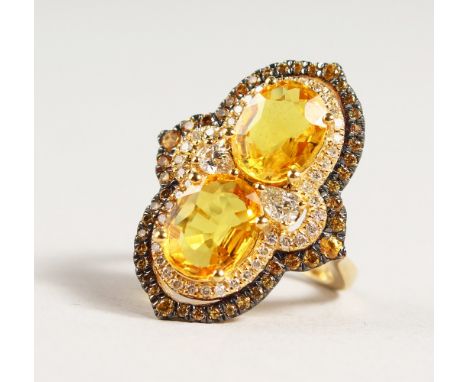 A VERY GOOD 18CT GOLD YELLOW SAPPHIRE AND DIAMOND RING.