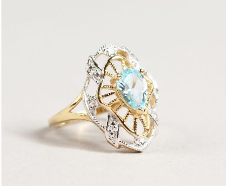A 9CT GOLD BLUE TOPAZ AND DIAMOND RING.