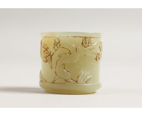 A CHINESE JADE ARCHER'S RING carved with figures and trees. 1ins long.