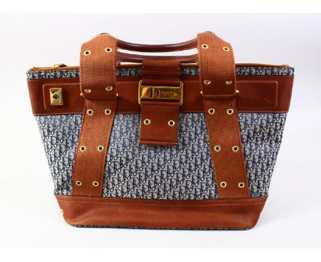 A CHRISTIAN DIOR FABRIC AND LEATHER BAG with dust dust cover.