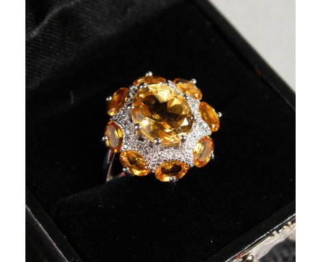 A SILVER AND CITRINE RING.