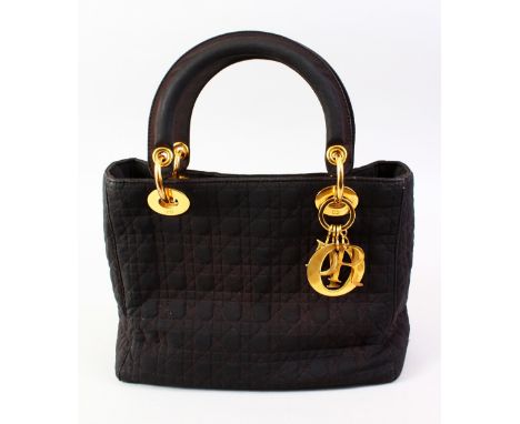 A CHRISTIAN DIOR BLACK BAG with gilt rings with dust cover.