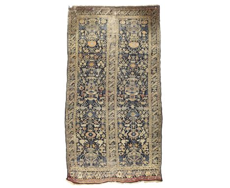 A Persian Karabagh carpet,  First quarter 20th century,   The two long fields with geometric vase of flower motifs surrounded