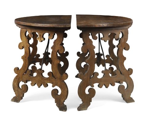 A Pair of Spanish walnut and chestnut demi-lune console tables, Last quarter 17th century, The shaped supports with iron stre