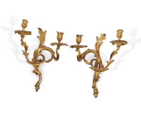 A pair of French ormolu twin-light wall appliques, In the manner of Jacques Caffiéri, possibly third quarter 18th century, Ea