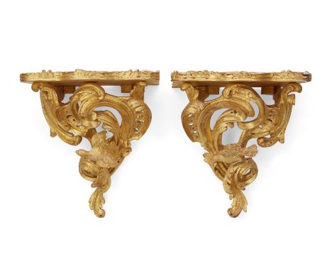 A pair of giltwood wall brackets,  Of Louis XV style, second half 20th century, Each with a projecting shelf with foliate ser