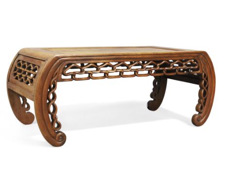 A Chinese hongmu low table, kang,Late Qing dynasty,With pierced frieze raised on curved scroll supports, 23cm high, 45cm wide