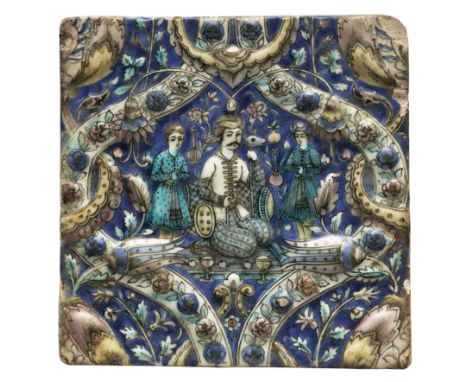 A square moulded polychrome pottery tile, Tehran, Qajar Iran, c.1880, A seated ruler flanked by attendants, within a strapwor