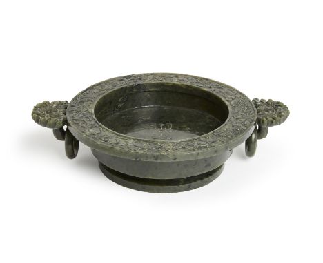 A Chinese spinach jade Qianlong-style 'marriage' bowl,&nbsp;20th century,With flat broad rim carved with lotus flowers, the i