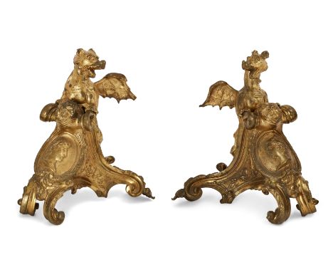 A pair of French ormolu chenets, Of Regence style, 19th century, Each mounted with a dragon, probably associated and possibly