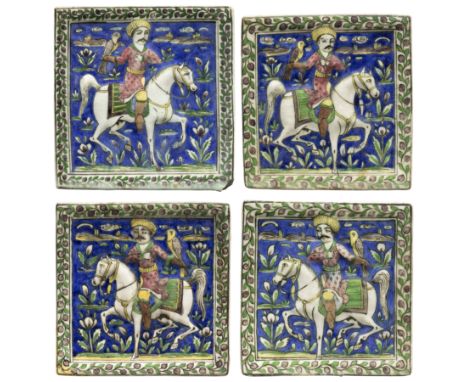 Four square moulded figural pottery tiles, Qajar Iran, c.1880 and later, Each representing a mounted hunter hawking, amidst f