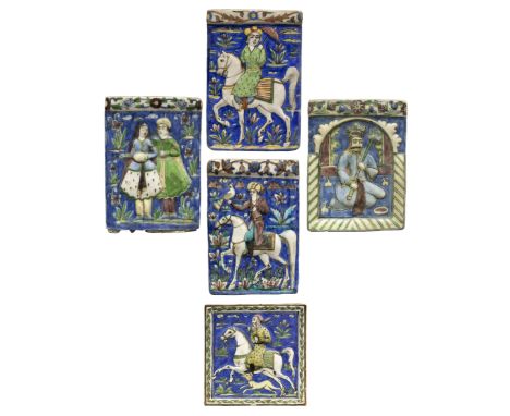 Five figural, polychrome moulded pottery tiles, Qajar Iran, c.1890, The first of rectangular form depicting a crowned ruler h