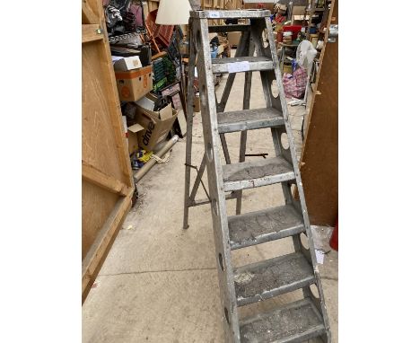 A VINTAGE SET OF METAL STEP LADDERS 