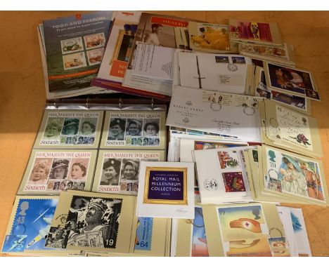 A LARGE QUANTITY OF FIRST DAY STAMPS AND POSTCARDS FEATURING 'THE MILLENNIUM COLLECTION' AND 'HER MAJESTY THE QUEEN' 