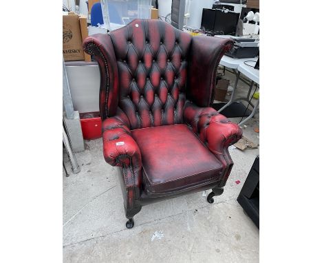 AN OX BLOOD LEATHER WING AND BUTTON BACK ARMCHAIR 
