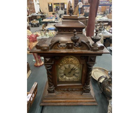 A LARGE WOODEN MANTEL CLOCK (FINIALS A/F) APPROXIMATE HEIGHT 60CM 