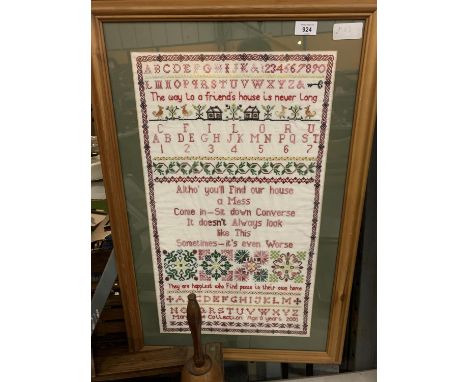 A LARGE WOODEN FRAMED EMBROIDERED SAMPLER 