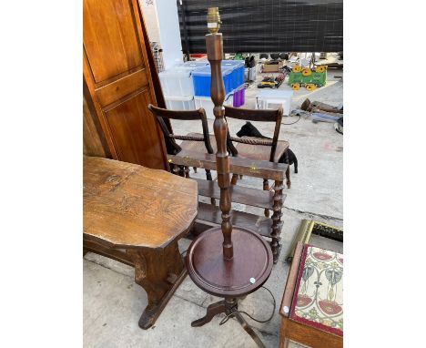 A MAHOGANY STANDARD LAMP ON TRIPOD SUPPORT WITH CIRCULAR LOWER SHELF 