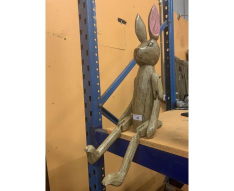 A LARGE WOODEN SHELF RABBIT 