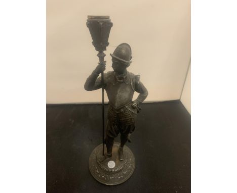 A VINTAGE SPELTER CANDLESTICK IN THE FORM OF A HISTORICAL FIGURINE 