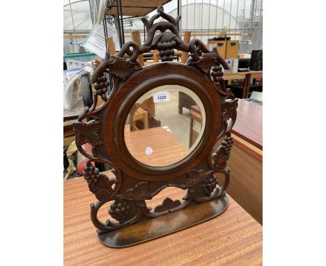 A VICTORIAN HEAVILY CARVED MAHOGANY BEVEL EDGED DRESSING TABLE MIRROR WITH LOWER SHELF 