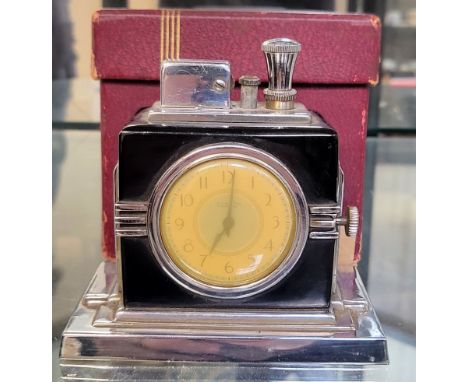 An Art Deco Ronson Touch Tip lighter watch combination, boxed. 9 x 10cm.There are remnants of the wick present. The box is or