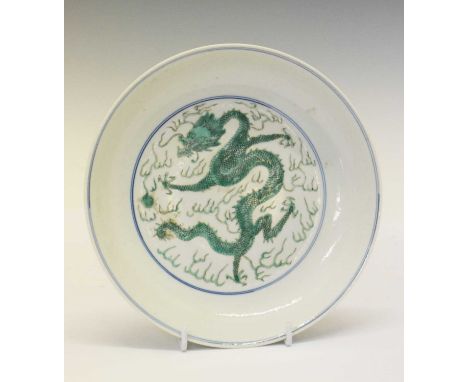 Chinese porcelain dragon dish, decorated in green enamels with a four clawed dragon chasing the flaming pearl of wisdom, bear