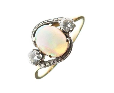 Opal and diamond three-stone ring, unmarked yellow and white metal mount, the oval opal cabochon approximately 6mm x 8mm x 2.