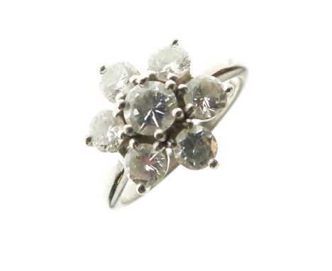 Seven-stone diamond flower head cluster ring, the white mount stamped '18ct Plat', the brilliant cuts totalling approximately