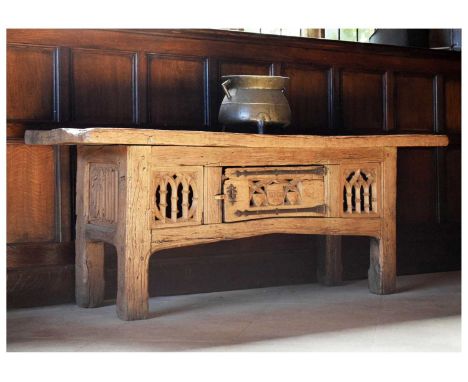 Oak table cupboard in the early 16th Century manner, with thick boarded top, central door pierced and carved with initials 'I