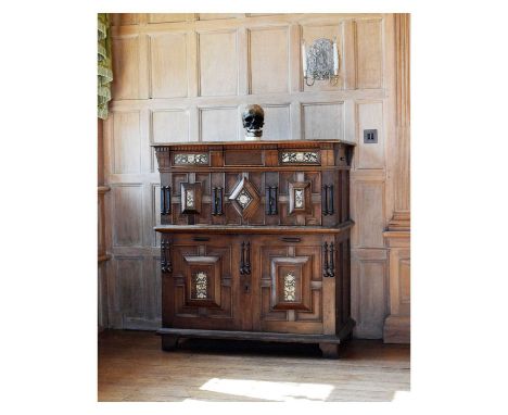 Dated mid-17th Century English oak, fruitwood and mother-of-pearl inlaid enclosed geometric chest of drawers, the boarded top