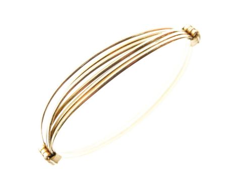 Continental wire strand bangle, stamped '18c', adjustable for size to a maximum internal diameter of approximately 8cm down t