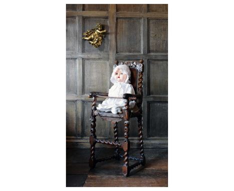 Late 17th Century child’s walnut highchair, circa 1680 and later, with shell-centred cresting, over cane back between spiral-