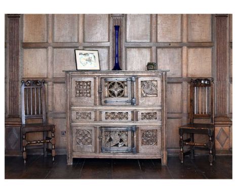 Oak aumbry, in the English manner of circa 1500, of three registers, the uppermost with pierced roundel to door flanked by qu