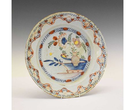 18th Century English delftware polychrome charger, painted with a flower vase within geometric and floral meander borders, 35