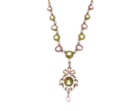 Peridot, pink tourmaline and seed pearl pendant necklace, the scroll work pendant with ribbon bow surmount, unmarked with thr