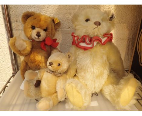 Three Steiff plush teddy bears with studs in ears
