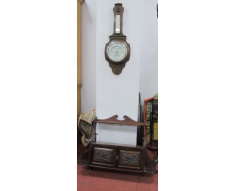 An Early XX Century Mahogany Wall Cabinet, with a swan neck pediment, over a single shelf, twin panelled doors, together with