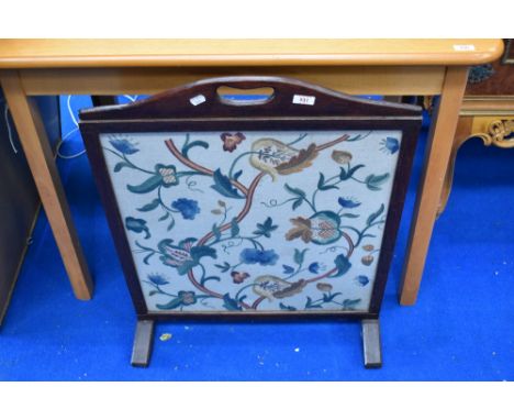 A traditional stained frame fire screen with embroidered insert