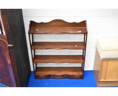 A reproduction Regency style wall shelf having three drawers