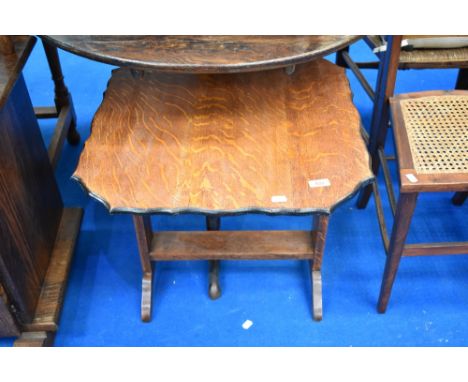 An early 20th Century oak occasional table having tilt top to convert to fire screen